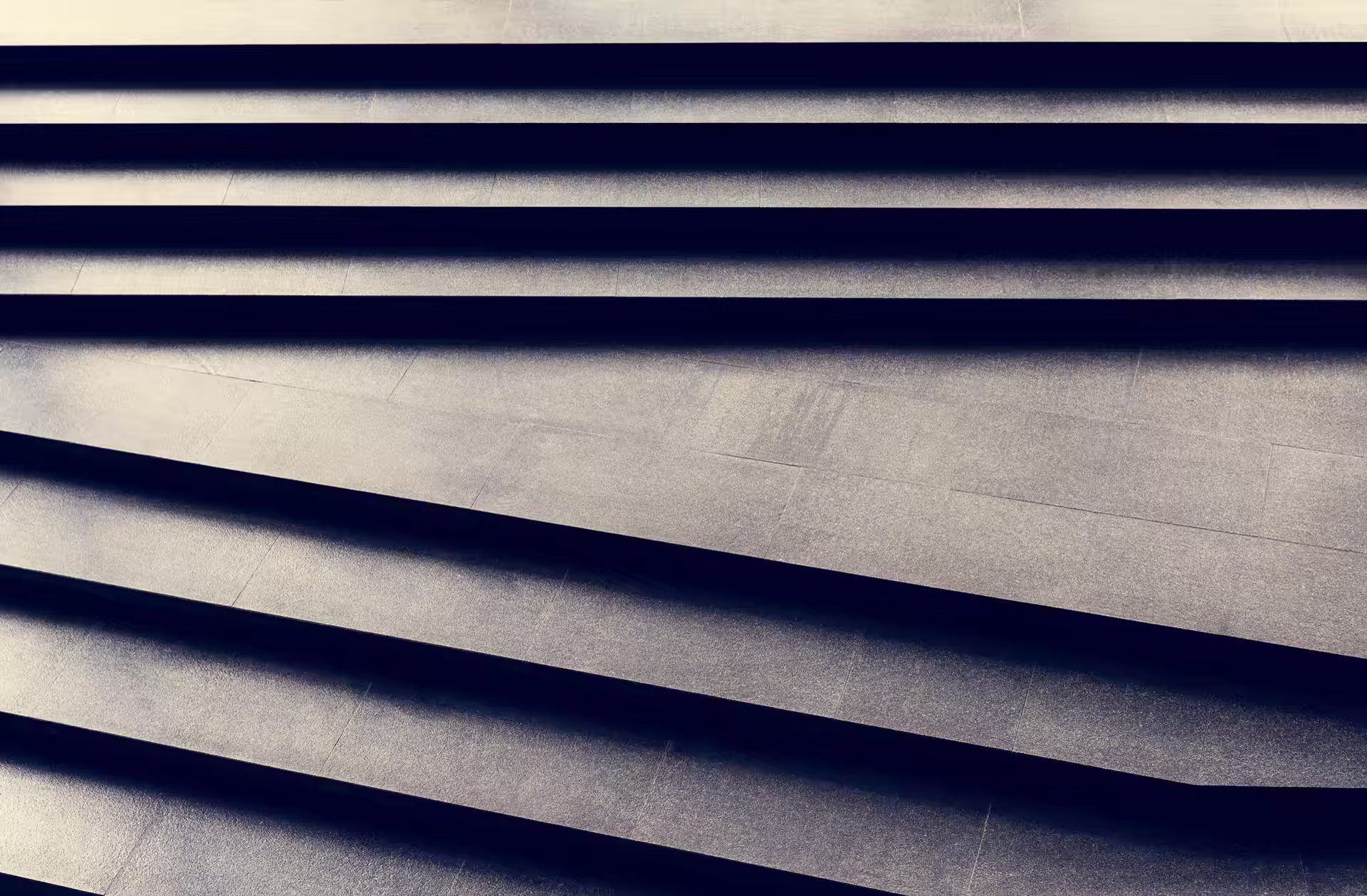 Dark granite stair treads in a repeating diagonal pattern